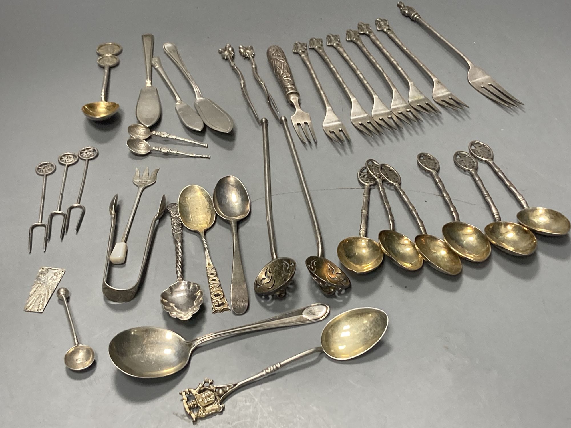 A group of assorted Chinese white metal spoons and forks, including set of six teaspoons and ten small items of English silver.